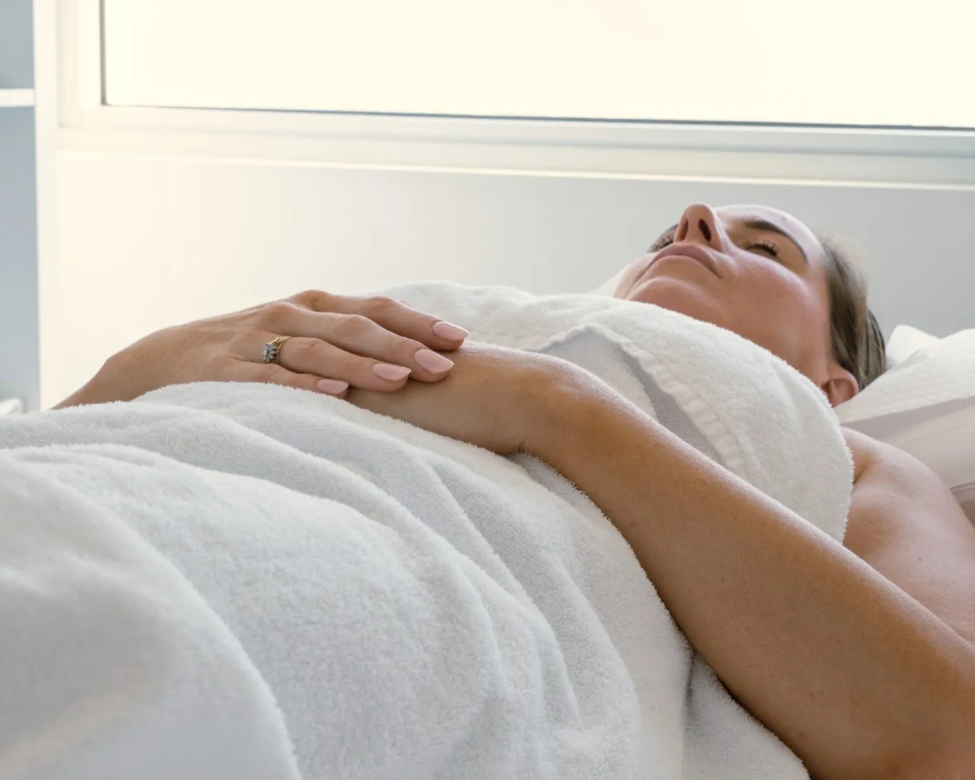 A woman relaxing during fertility acupuncture